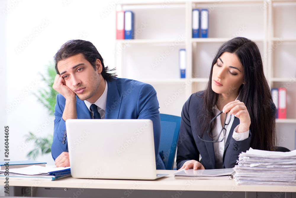 Two employees working in the office Two employees working in the office