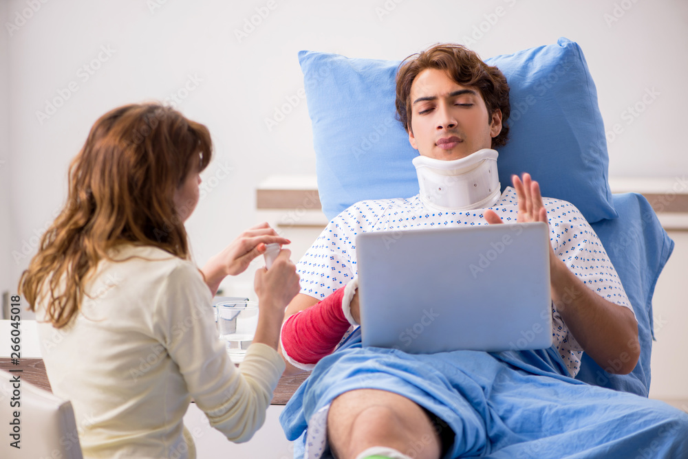 Fototapeta premium Loving wife looking after injured husband in hospital 