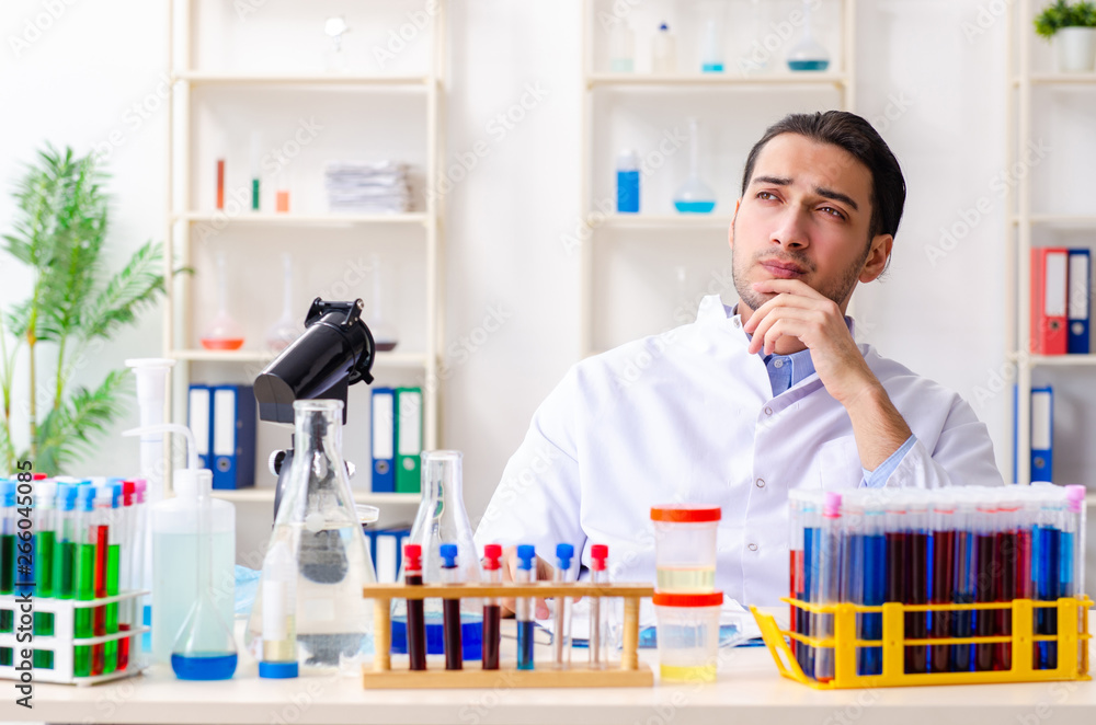 Young male chemist working in the lab Young male chemist working in the lab