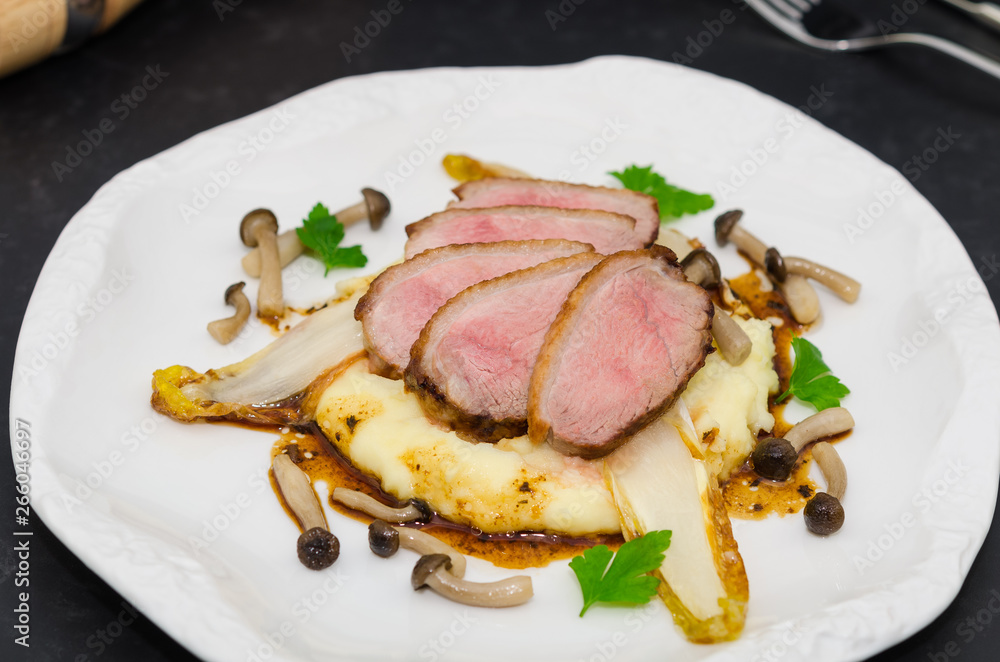 Roasted breast duck. Duck breast fillets with mashed potatoes, endives and mushrooms Roasted breast duck. Duck breast fillets with mashed potatoes, endives and mushrooms