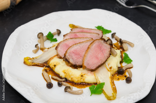 Roasted breast duck. Duck breast fillets with mashed potatoes, endives and mushrooms 