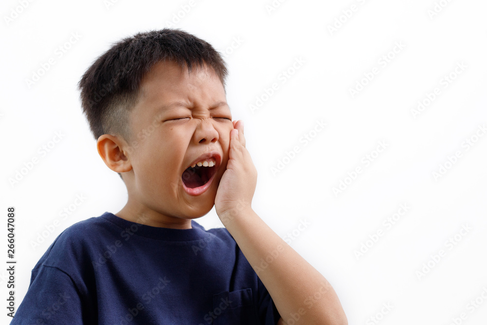 Asian kid suffering from toothache pain, holding his cheek, isolated on white background. Dental Health And Care Concept. Asian kid suffering from toothache pain, holding his cheek, isolated on white background. Dental Health And Care Concept.
