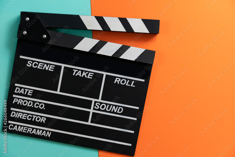 movie clapper on color background ; film, cinema and video photography concept