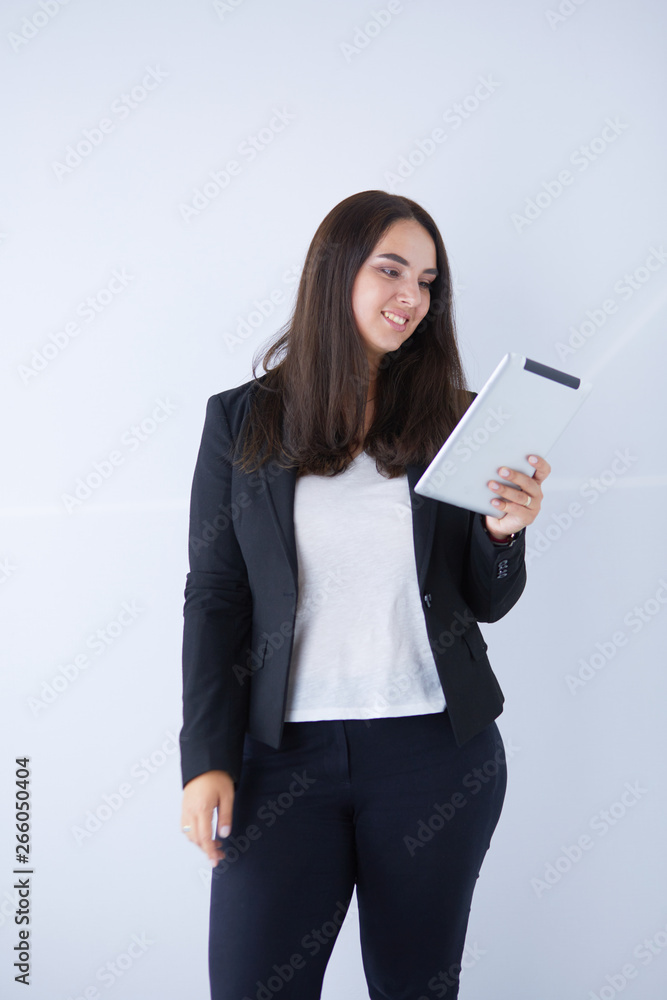 Portrait of smiling young business woman with digital tablet in her hands. Portrait of smiling young business woman with digital tablet in her hands.