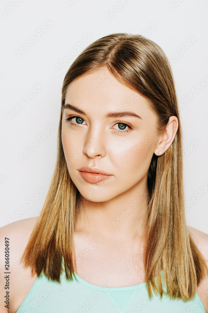 Close up portrait of beautiful young woman with blond hair and nude make up Close up portrait of beautiful young woman with blond hair and nude make up