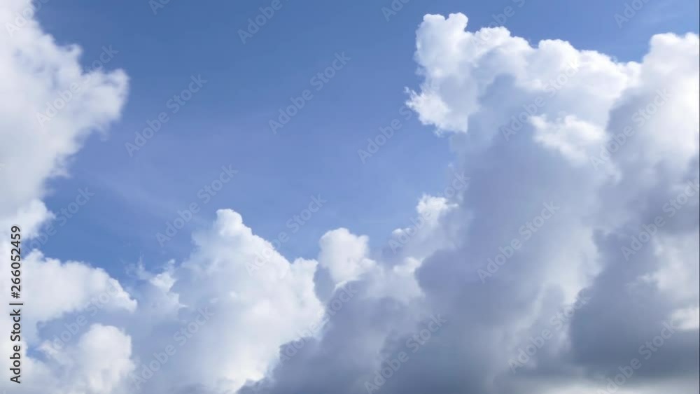 A time lapse of white clouds moving across a blue sky. A time lapse of white clouds moving across a blue sky.