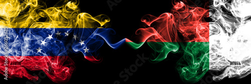Venezuela vs Madagascar  Madagascan smoky mystic flags placed side by side. Thick colored silky smoke flags of Venezuela and Madagascar  Madagascan