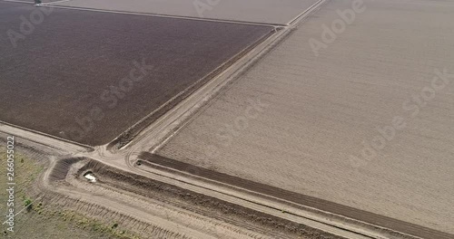 Plowed black rich soil on agriculture farm with cultivation and agronomy around Moree regional town in elevated aerial view. photo