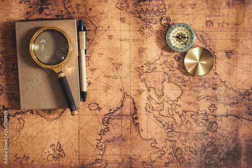 Navigation Travel Explore Journey and Destination Vacation Planning ,Exploration The World for Holiday Trip Concept. Layout of Notebook, Magnifying Glass and Navigator Compass on Global Map Background