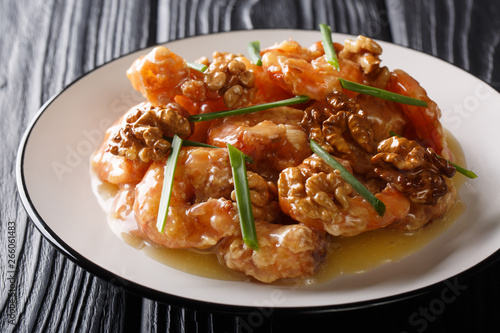 Crunchy shrimp with honey, candied walnut, and sweet mayo close-up. horizontal