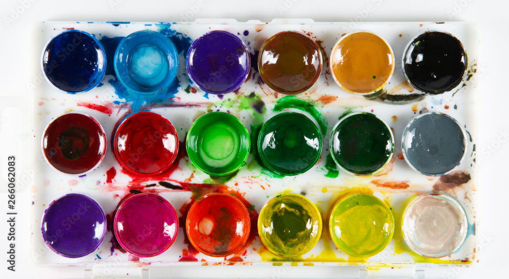 A set of children's paints in circular forms close-up