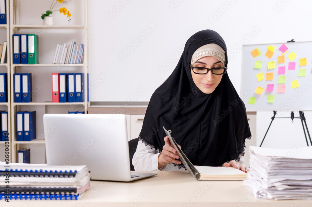 Female employee in hijab working in the office Female employee in hijab working in the office