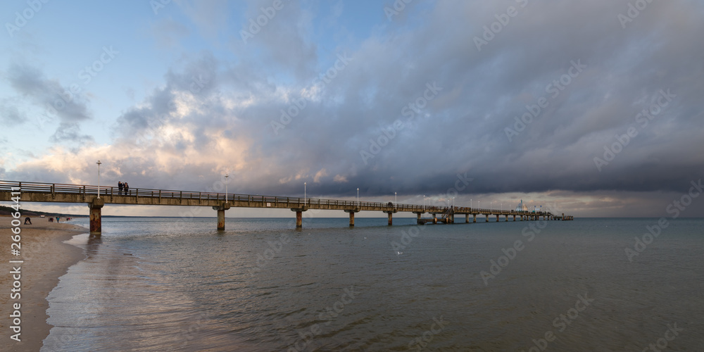 Sea bridge at the Baltic Sea against a dramatic sky with clouds 