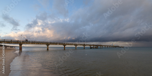 Sea bridge at the Baltic Sea against a dramatic sky with clouds 