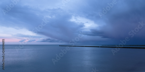 Stormy sunset at the Baltic Sea against blue sky.