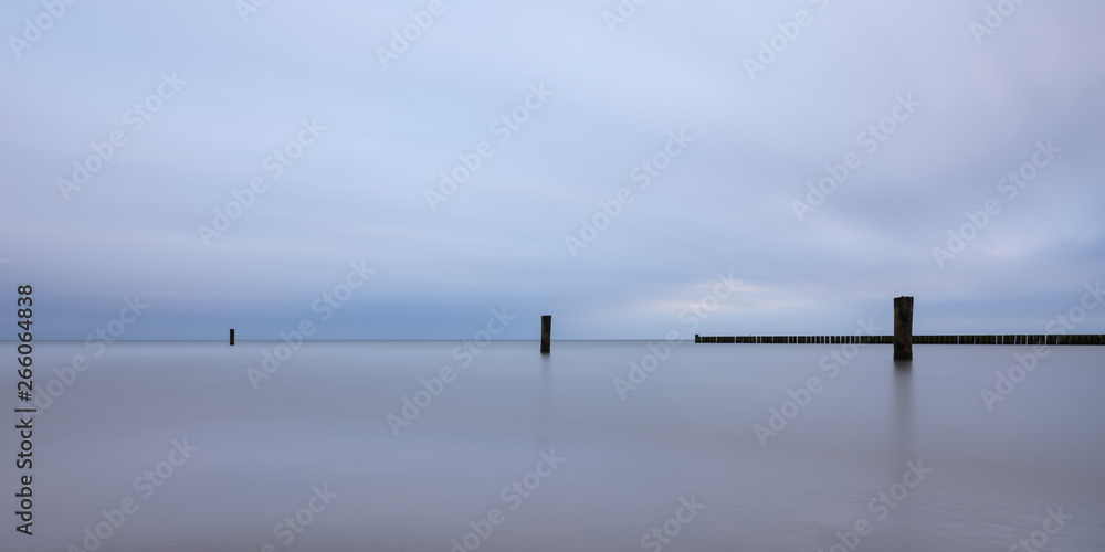 Long exposure at the Baltic Sea against dramatic blue sky