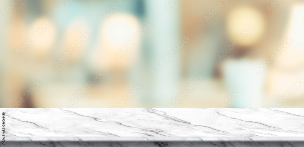 Empty white marble table and blurred soft light table in luxury restaurant with bokeh background. product display template.Business presentation Empty white marble table and blurred soft light table in luxury restaurant with bokeh background. product display template.Business presentation