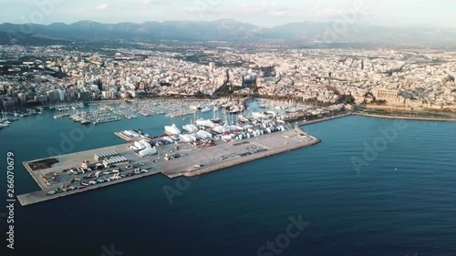 Picturesque aerial view of the coastal city harbour with many boats, mountains and cloudy sky. Stock. Beautiful sea port and the blue sea.