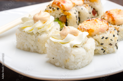 Portion of Sushi Rolls on white platte.