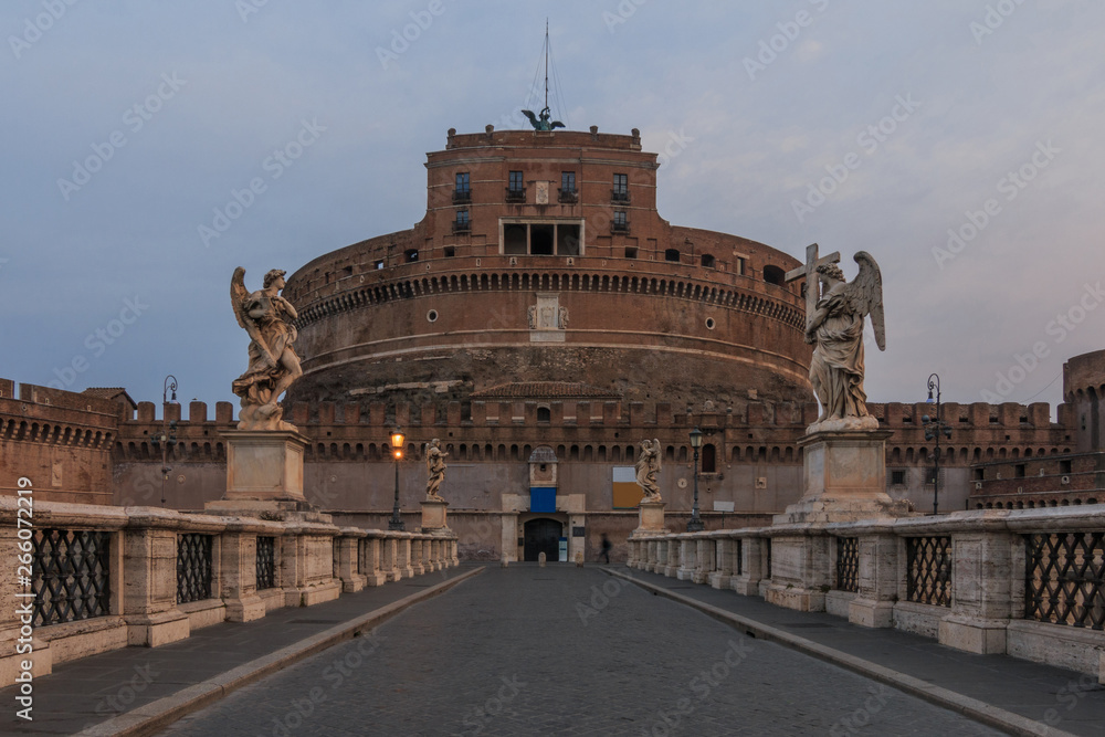 Castle Sant Angelo with the Aurelius bridge in the morning at dusk. Stone bridge with figures over river Tiber without persons and with clouds in the sky