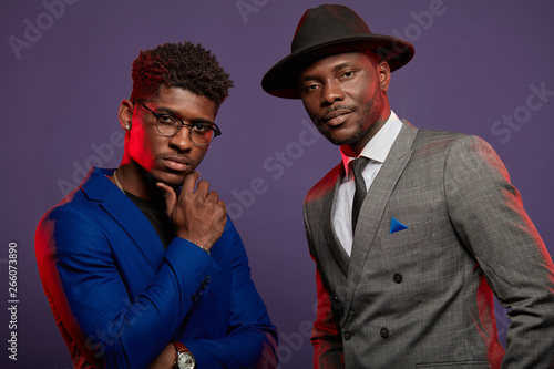 Foto Positive african ethnicity businessmen, well-dressed business partners wearing stylish suits looking at camera isolated in studio