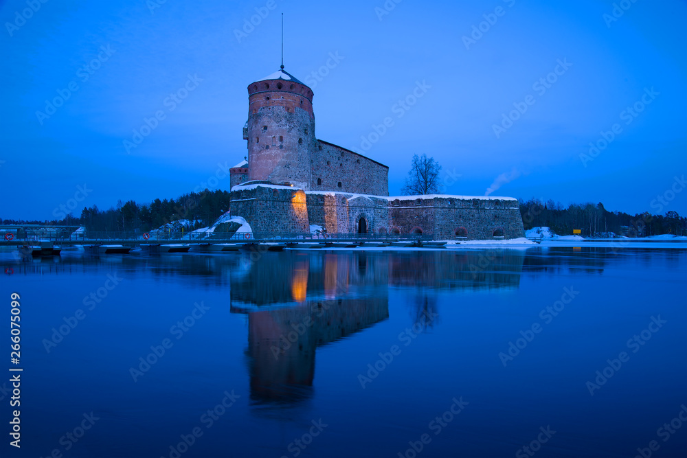 Olavinlinna fortress in March twilight. Savonlinna, Finland