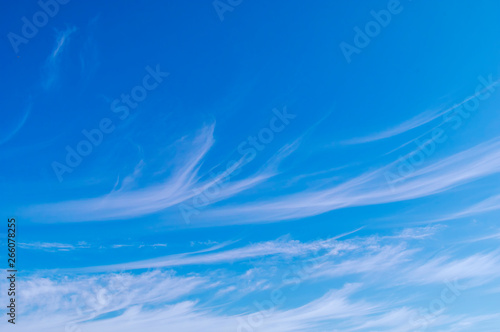 Blue sky with white cirrus clouds sunny panorama.