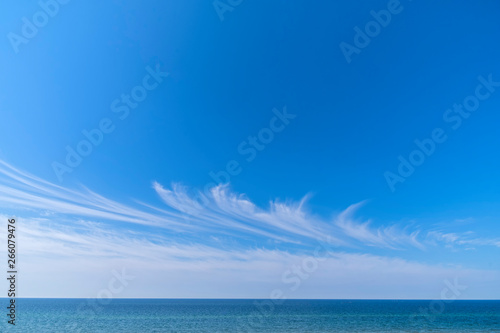 Blue sky cirrus clouds sea panorama.