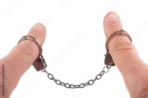 Handcuffs on man's fingers on white background