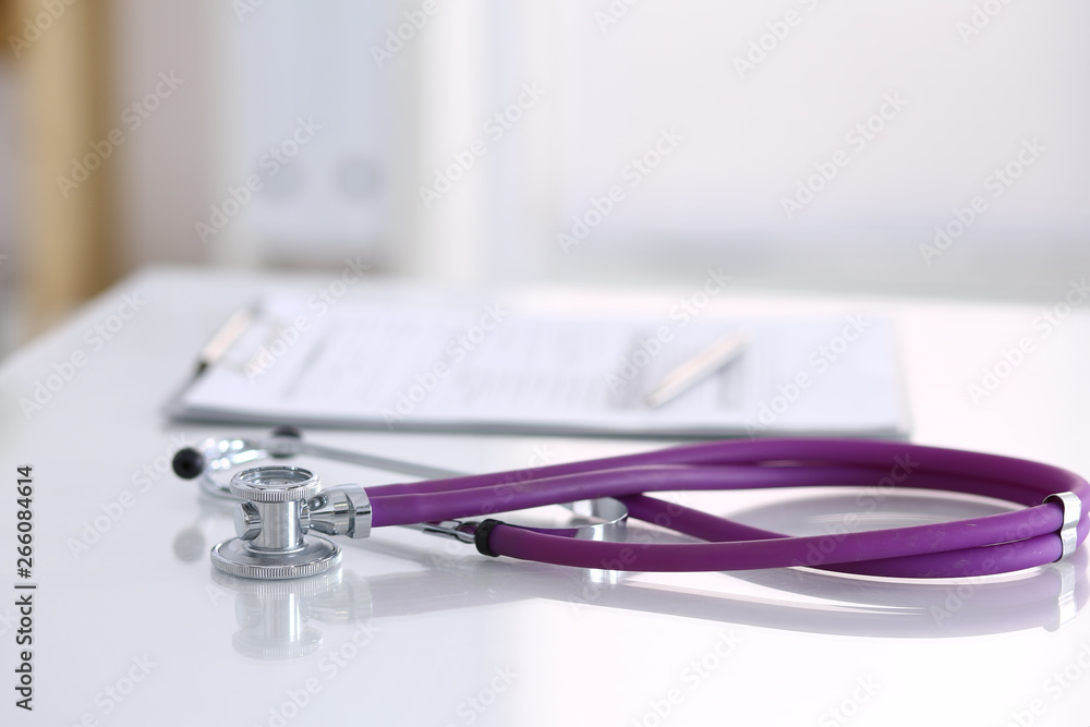 Medication history record form lying on table with stethoscope and silver pen. Medicine or pharmacy concept. Medical tools at doctor working table Medication history record form lying on table with stethoscope and silver pen. Medicine or pharmacy concept. Medical tools at doctor working table