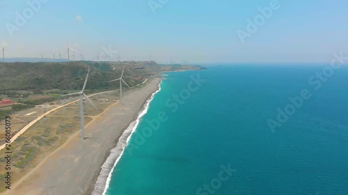 Wallpaper Mural Aerial, a field of wind power generation installed on the shores of a beautiful beach with white sand and turquoise water Torontodigital.ca