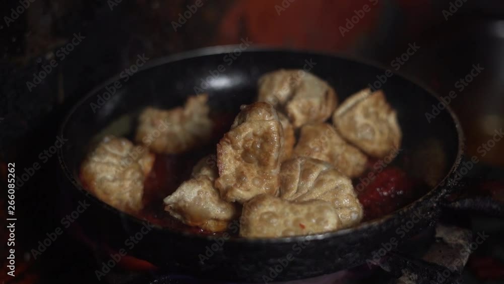 A chef is roasting and mixing the delicious pork pieces in a hot pan while flames everywhere around the pan. Amazing close-up and slow motion footage in cooking, kitchen, dish and eat concept. A chef is roasting and mixing the delicious pork pieces in a hot pan while flames everywhere around the pan. Amazing close-up and slow motion footage in cooking, kitchen, dish and eat concept.