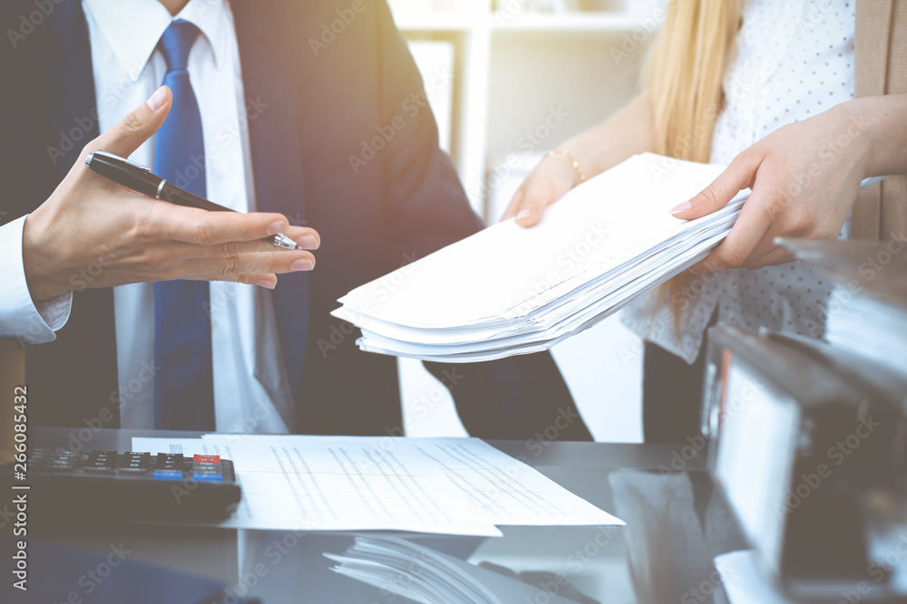 Fototapeta premium Bookkeeper or financial inspector hands making report, calculating or checking balance. Internal Revenue Service inspector man checking financial document. Business, tax and audit concepts