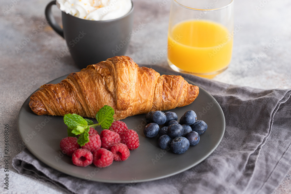 Continental breakfast, French croissant, coffee with milk, fruit and orange juice. Good morning concept. Continental breakfast, French croissant, coffee with milk, fruit and orange juice. Good morning concept.
