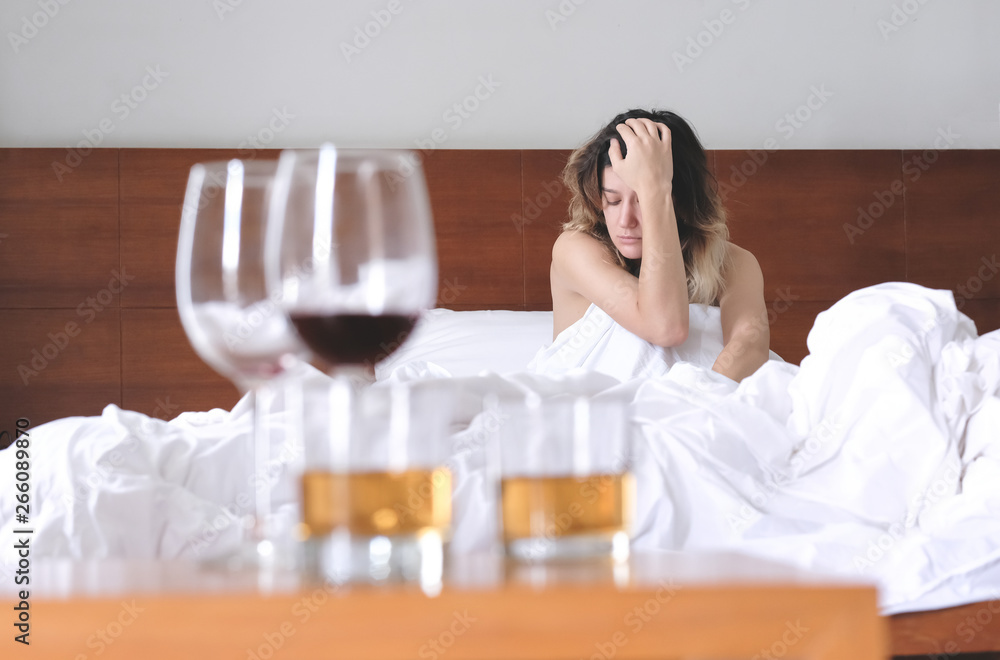 Cheating wife. Unfaithful woman in lover's bed in the morning regretting about last night Cheating wife. Unfaithful woman in lover's bed in the morning regretting about last night