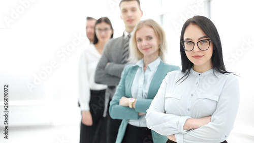 confident businesswoman standing in front of his business team
