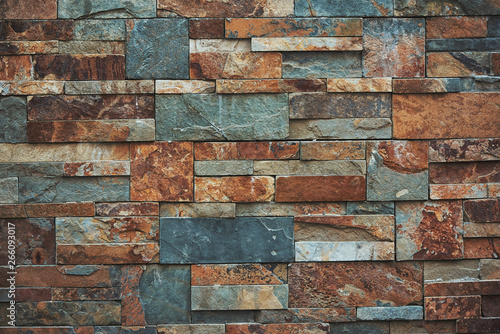 Urban stone wall texture background. teal and orange colors.