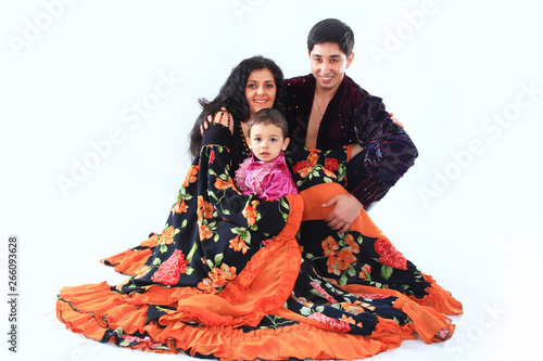 portrait of a Gypsy couple with a cute son in their national costumes