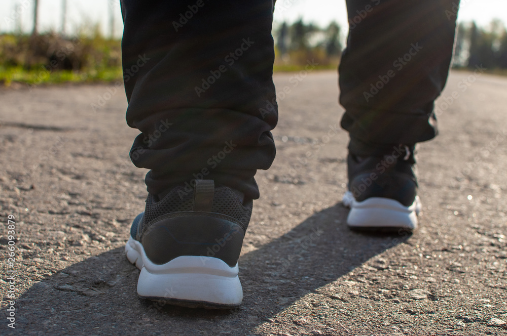 running shoes on the pavement during the morning jog running shoes on the pavement during the morning jog