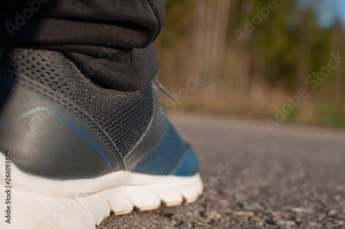 running shoes on the pavement during the morning jog