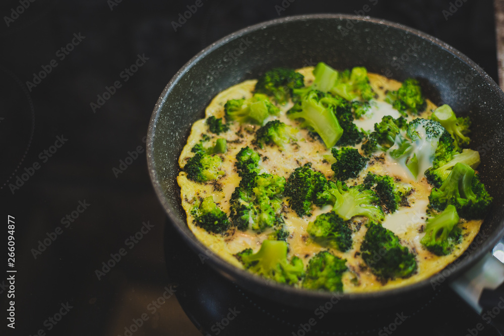 broccoli with eggs in a frying pan broccoli with eggs in a frying pan