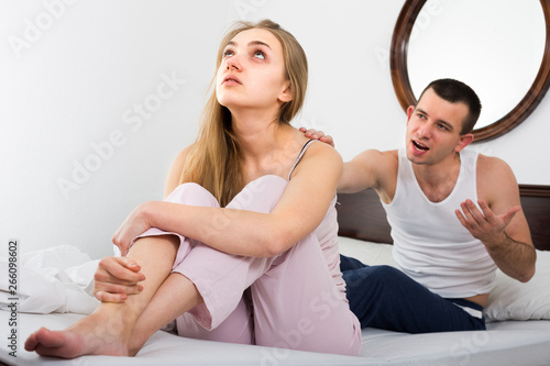Young couple conflict in bedroom .
