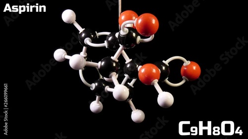 Aspirin C9H8O4 molecule rotating on black background photo