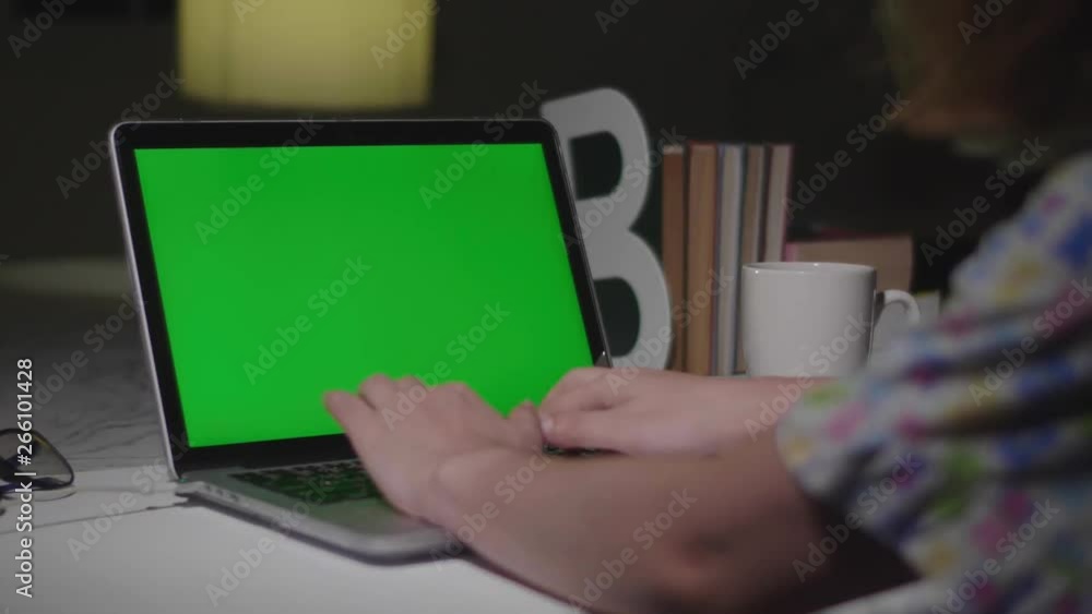 Laptop with green screen. Dark office. Dolly shot. Perfect to put your own image or video. Laptop with green screen. Dark office. Dolly shot. Perfect to put your own image or video.