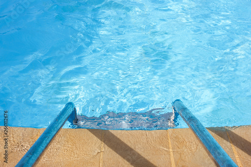 Clear blue water and a ladder in the pool