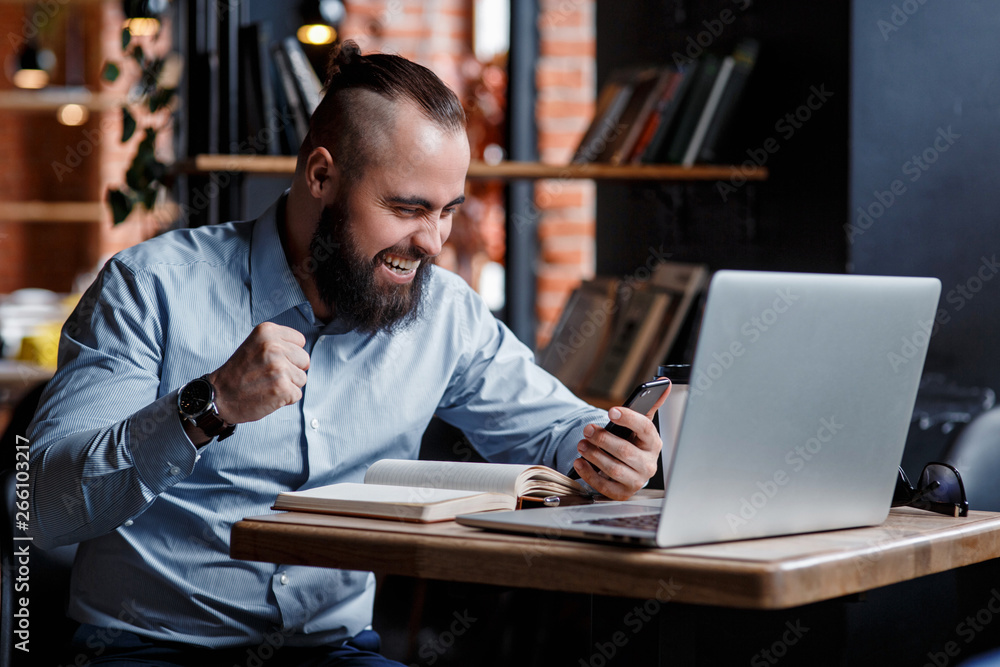 Euphoric happy businessman scream read good online news celebrating business success, great result watching game on laptop, excited by victory, betting win, professional achievement, feeling winner