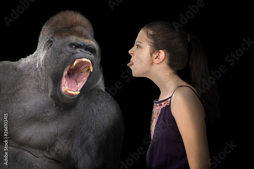 Brave young girl defying an angry gorilla