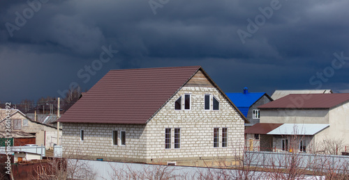 Black clouds over the house in the village