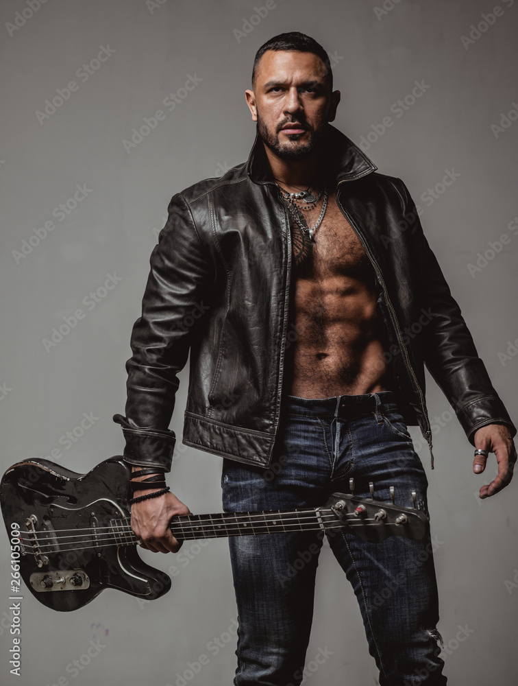 Rock this party. Muscular athletic sexy male with guitar. Confident and  handsome brutal man play music. Party for adults. Music dance party. Move  your body. Enjoy perfect sound. Rock musician concept Photos
