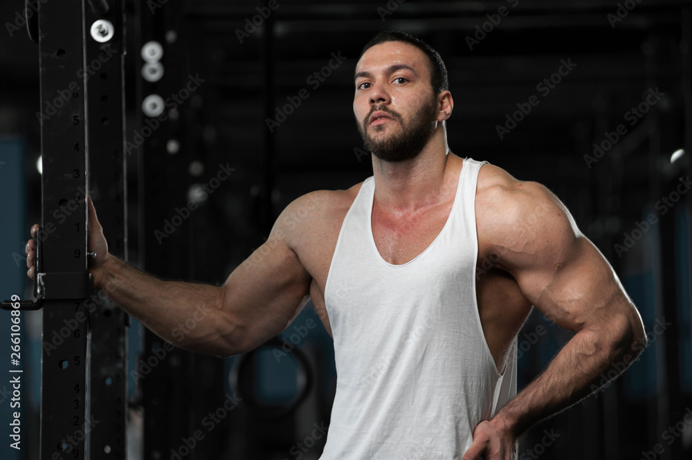 Fototapeta premium Sporty Athlete Posing on Background of Gym
